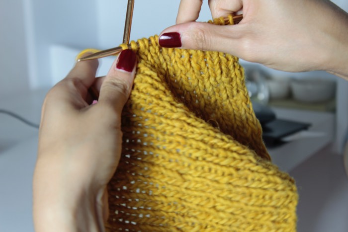 Knitting yellow wool
